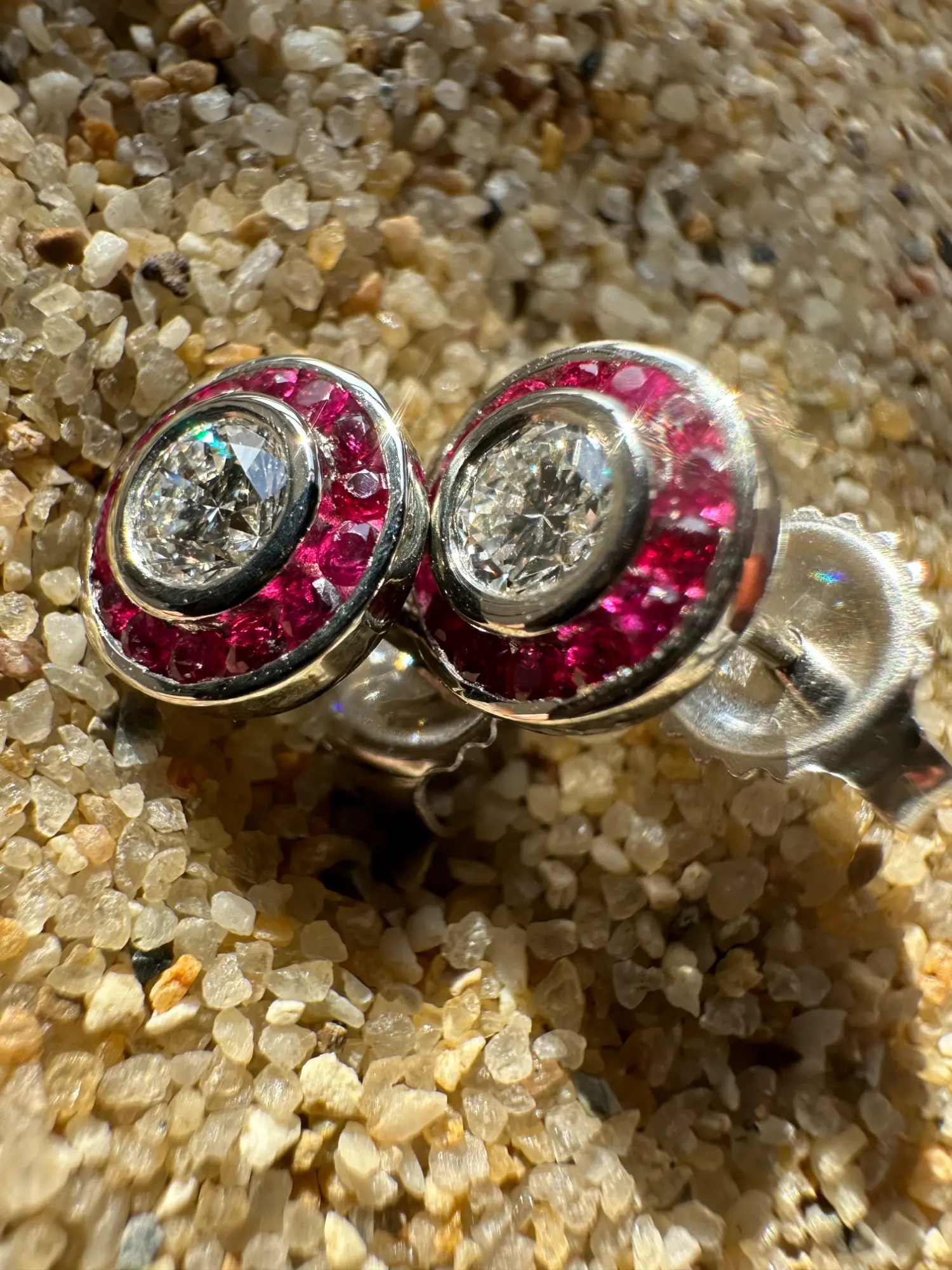 A colorful green and blue ring is positioned atop a lush green leaf, highlighting the beauty of natural elements.