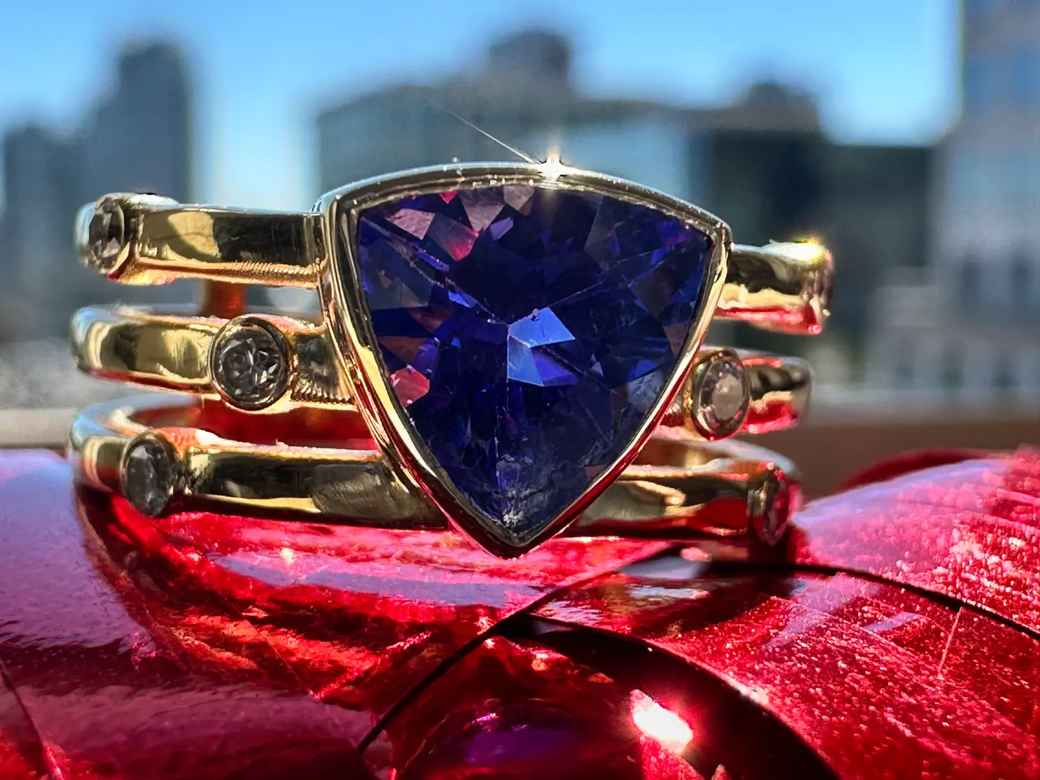 An elegant ring adorned with a stunning emerald stone, highlighting its deep green color against a sleek band.