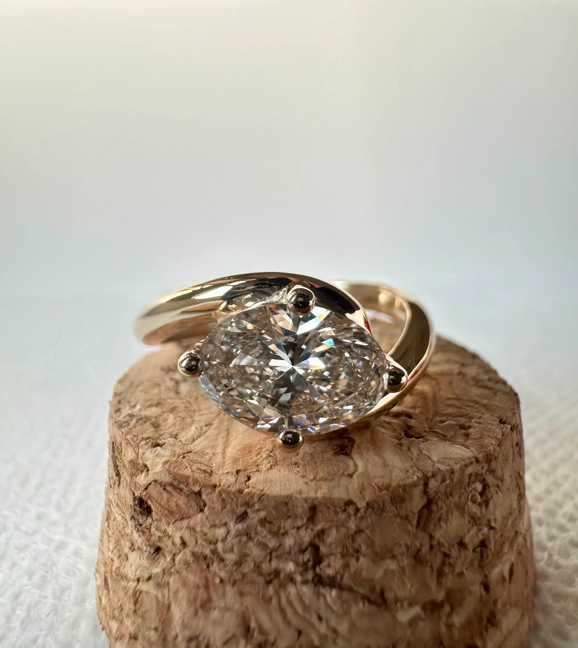 A stunning yellow diamond ring nestled within a circle of bright yellow flowers, symbolizing beauty and elegance.