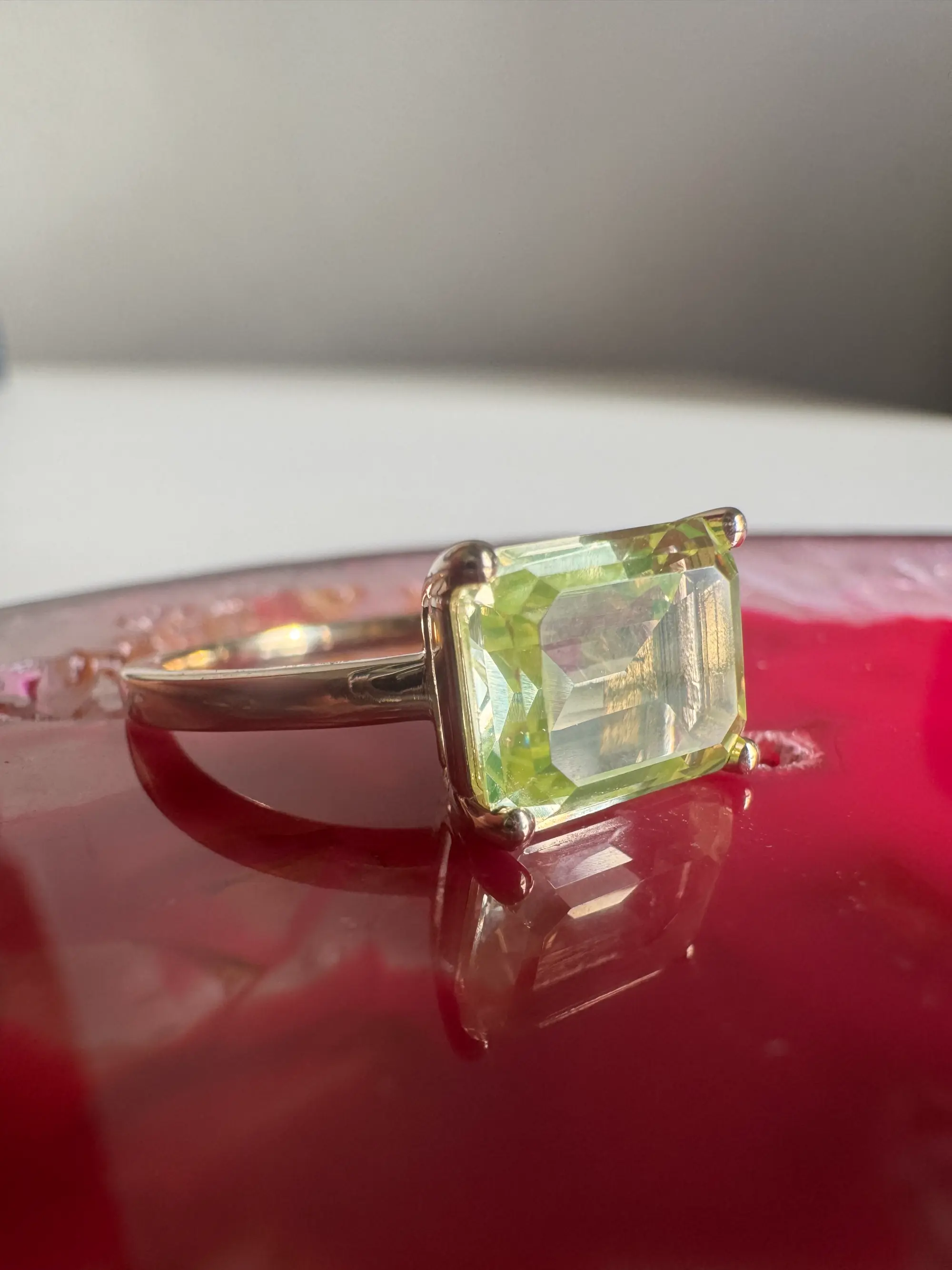 A stunning yellow diamond ring nestled within a circle of bright yellow flowers, symbolizing beauty and elegance.