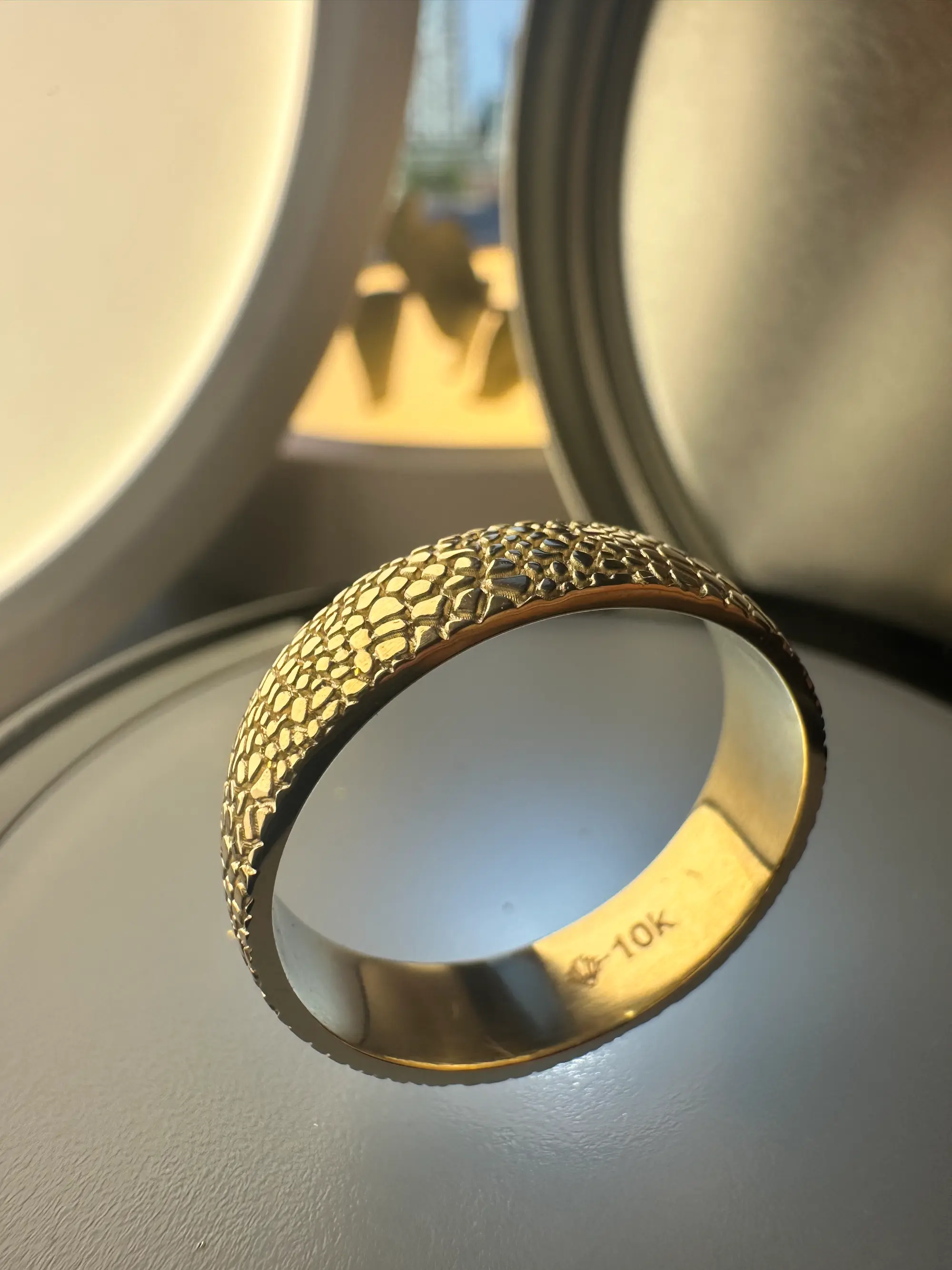 A stunning yellow diamond ring nestled within a circle of bright yellow flowers, symbolizing beauty and elegance.