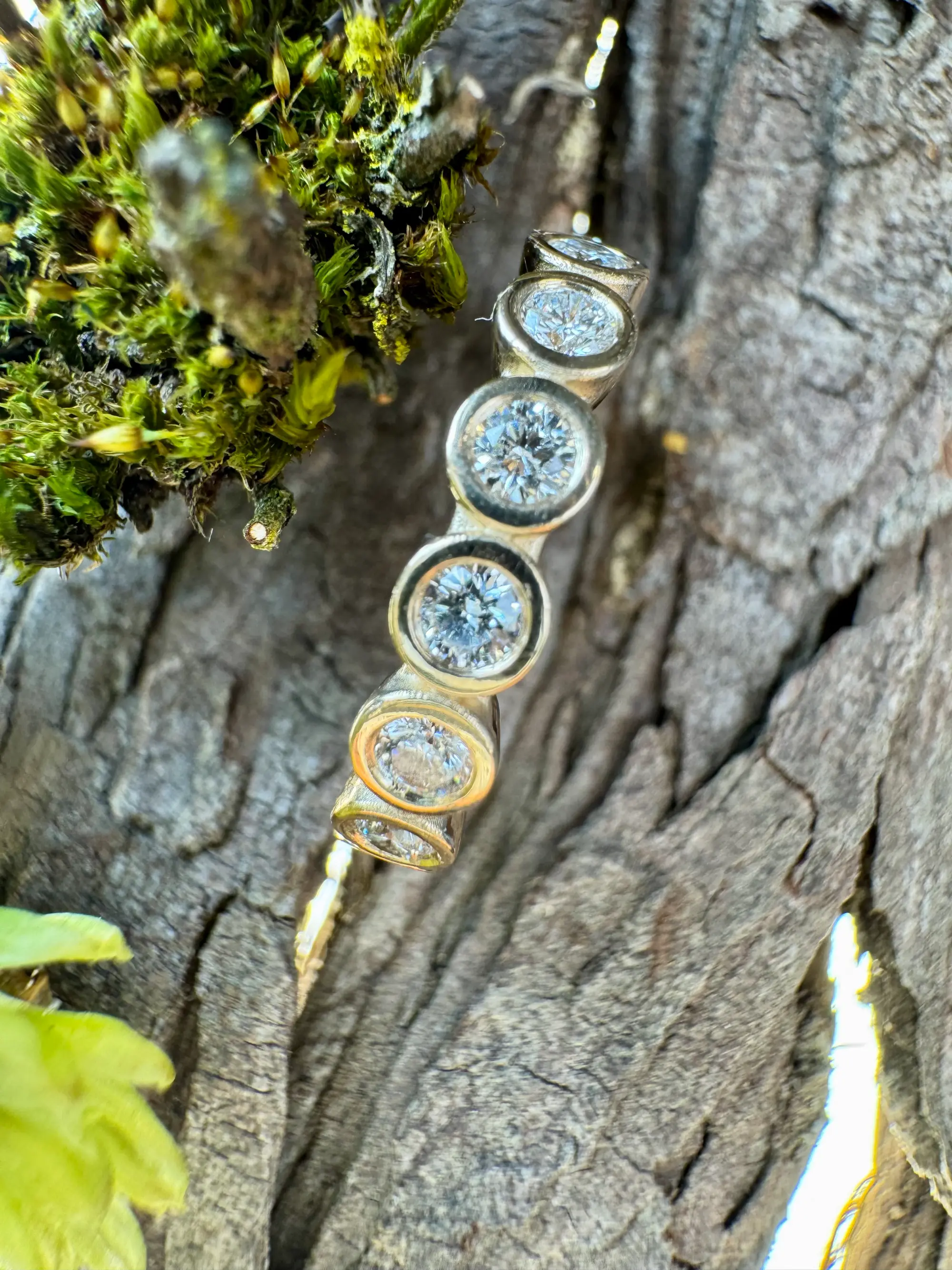 A stunning yellow diamond ring nestled within a circle of bright yellow flowers, symbolizing beauty and elegance.
