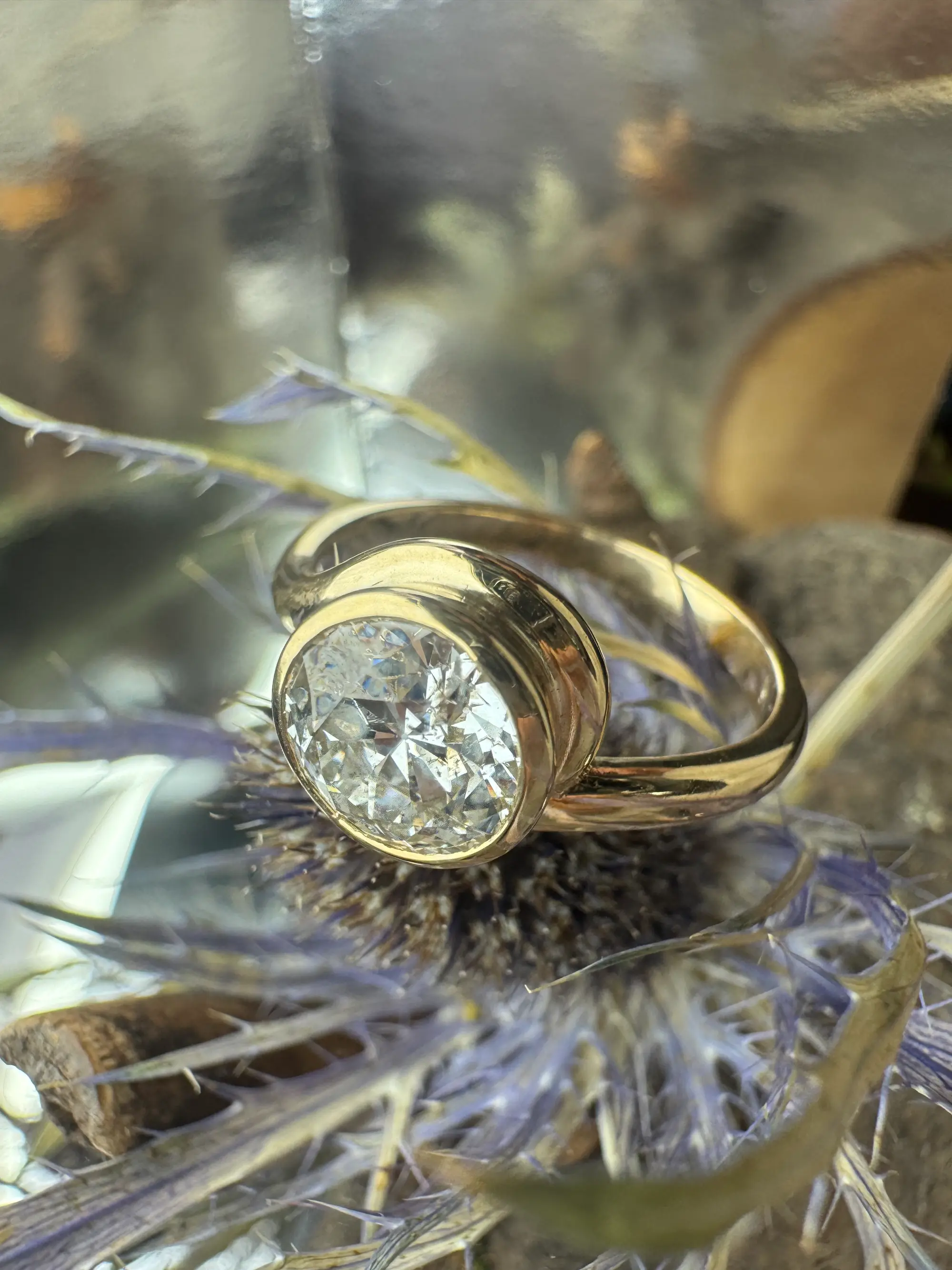 A stunning yellow diamond ring nestled within a circle of bright yellow flowers, symbolizing beauty and elegance.