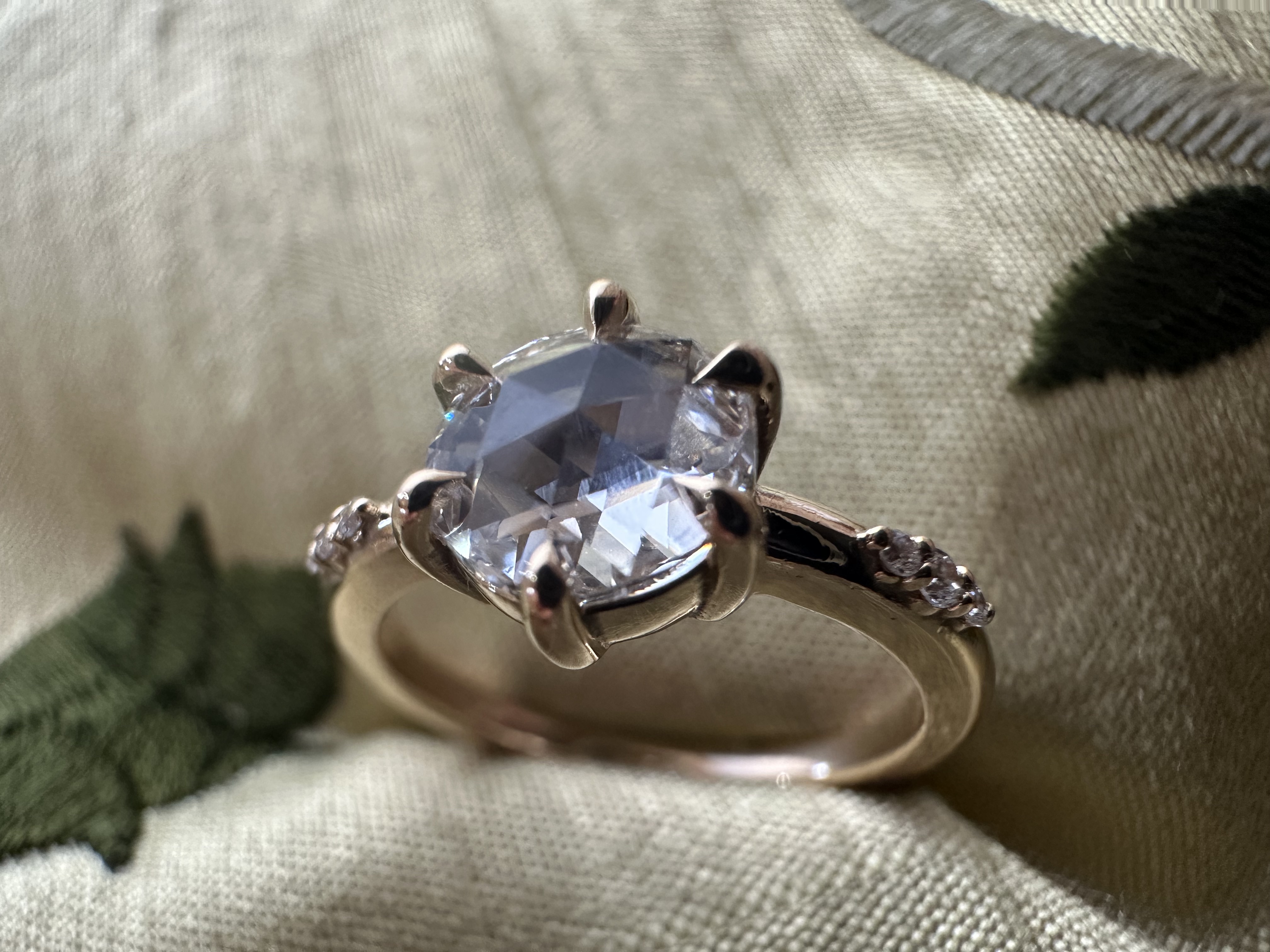 A stunning yellow diamond ring nestled within a circle of bright yellow flowers, symbolizing beauty and elegance.