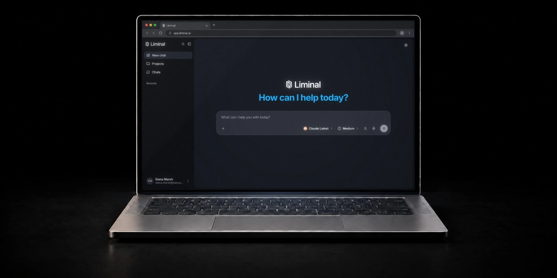 Laptop on a dark surface showing a new chat in the Liminal workspace, with Claude Latest selected