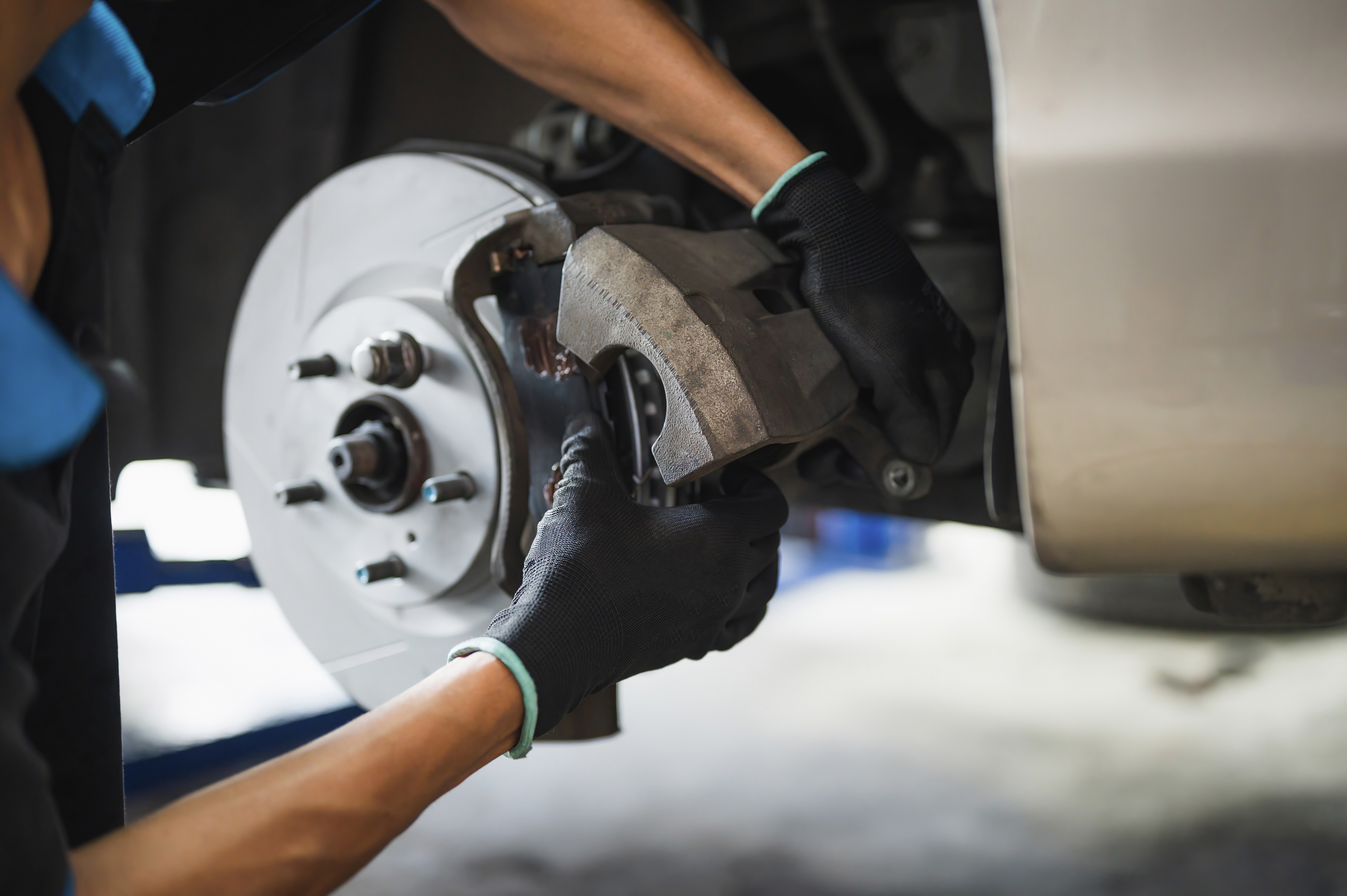 Mechanic inspecting and checking the brakes on a car
