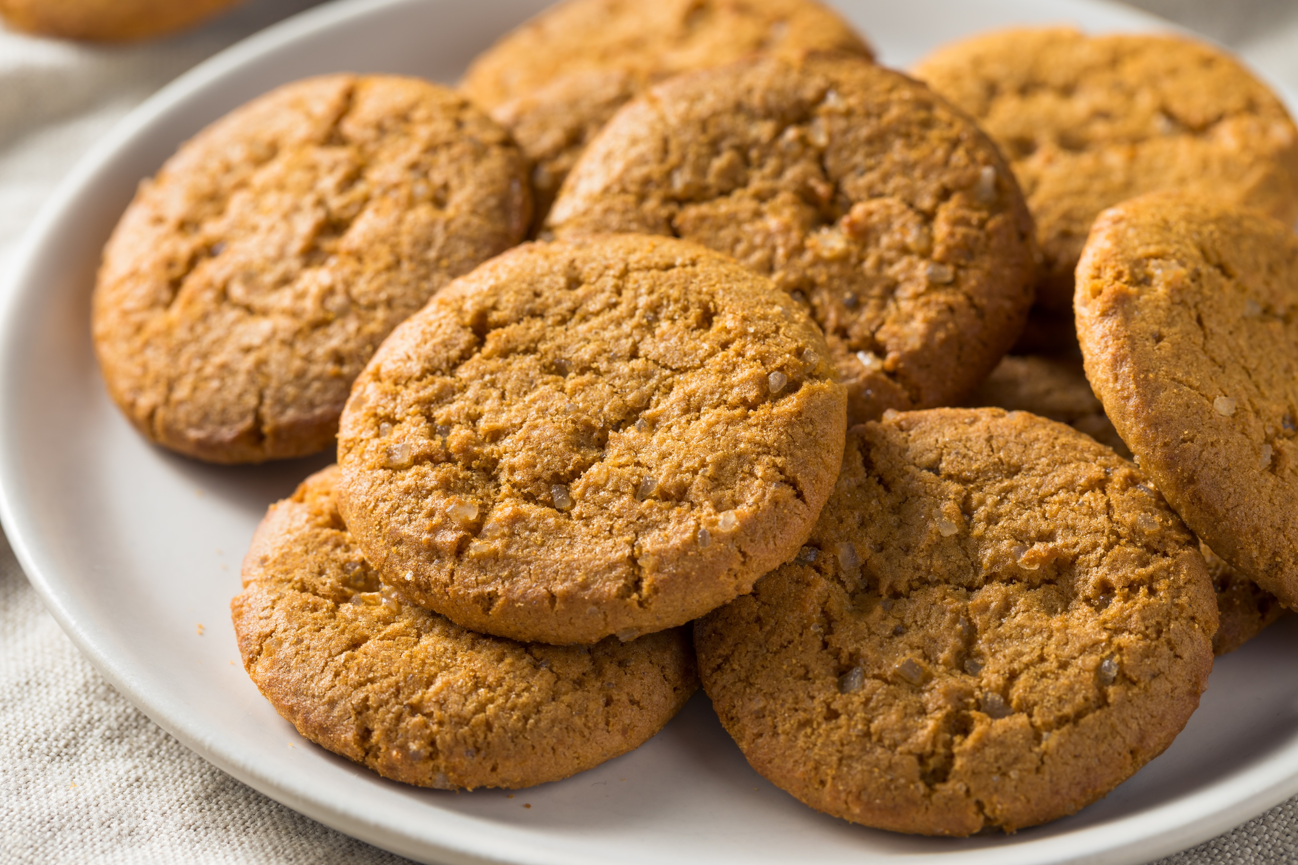 a white plate covered with ginger snap cookies