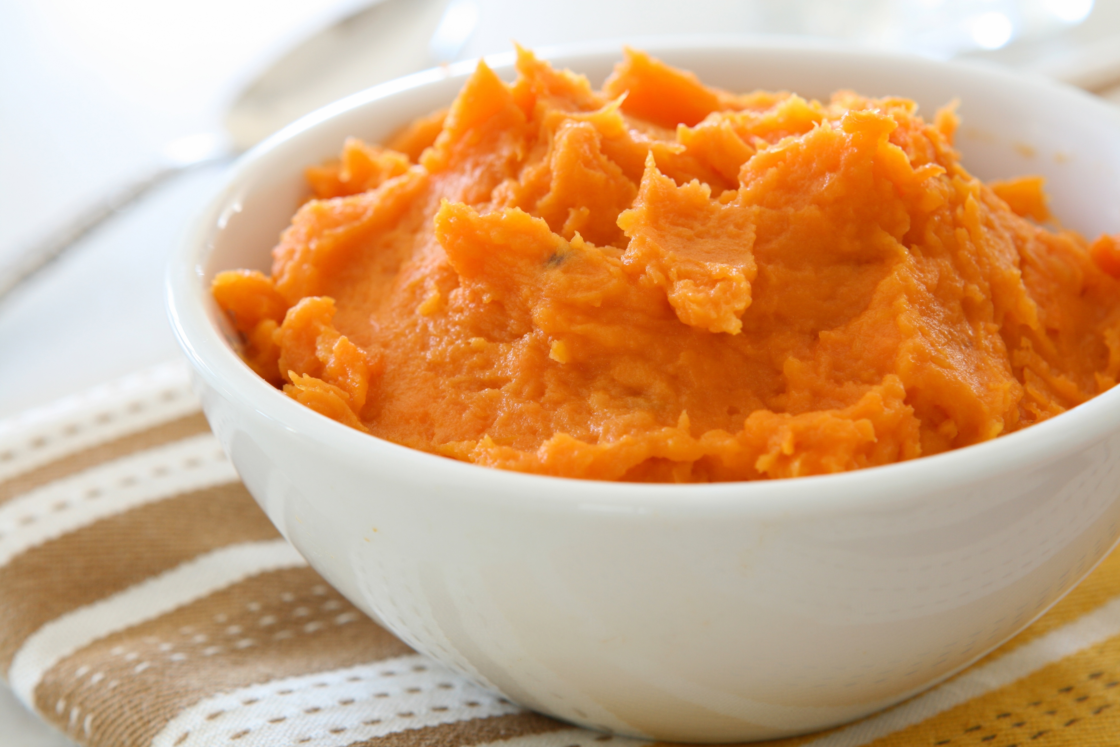 White bowl filled with mashed sweet potatoes