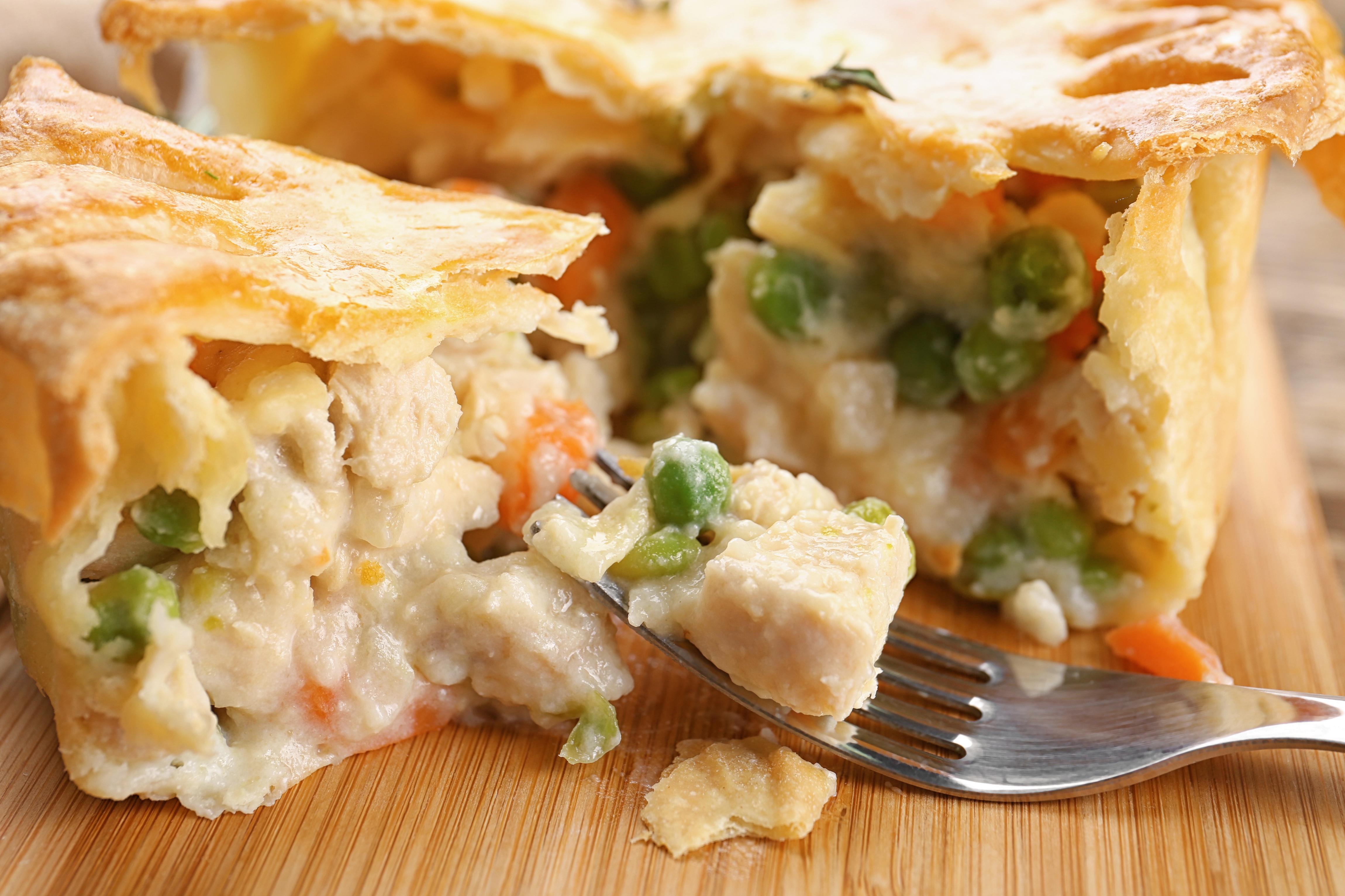 Chicken pot pie being eaten with a silver fork