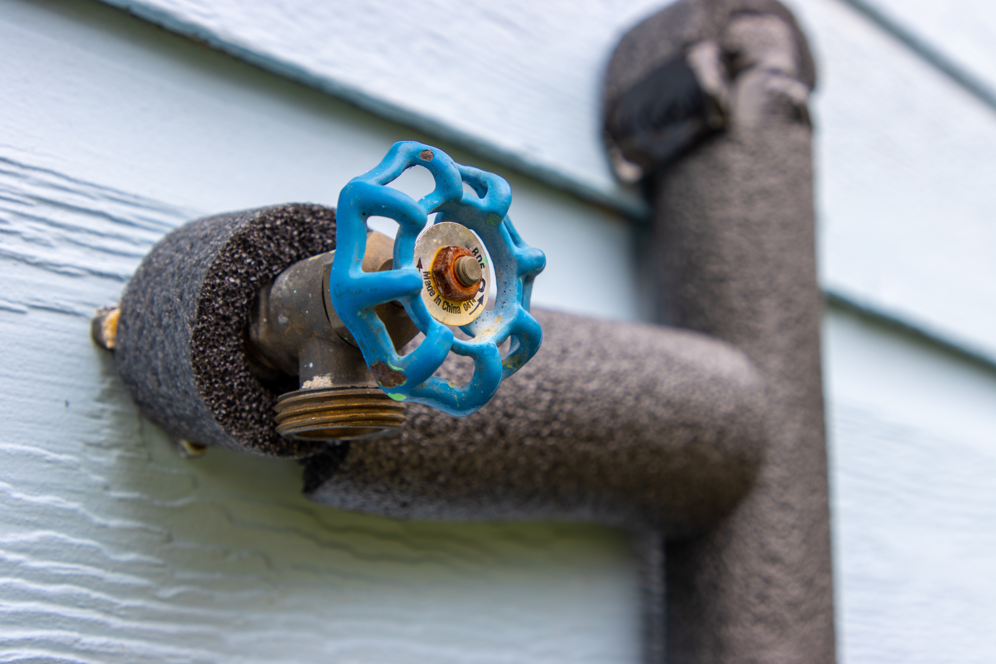 Water pipes covered up with gray insulation
