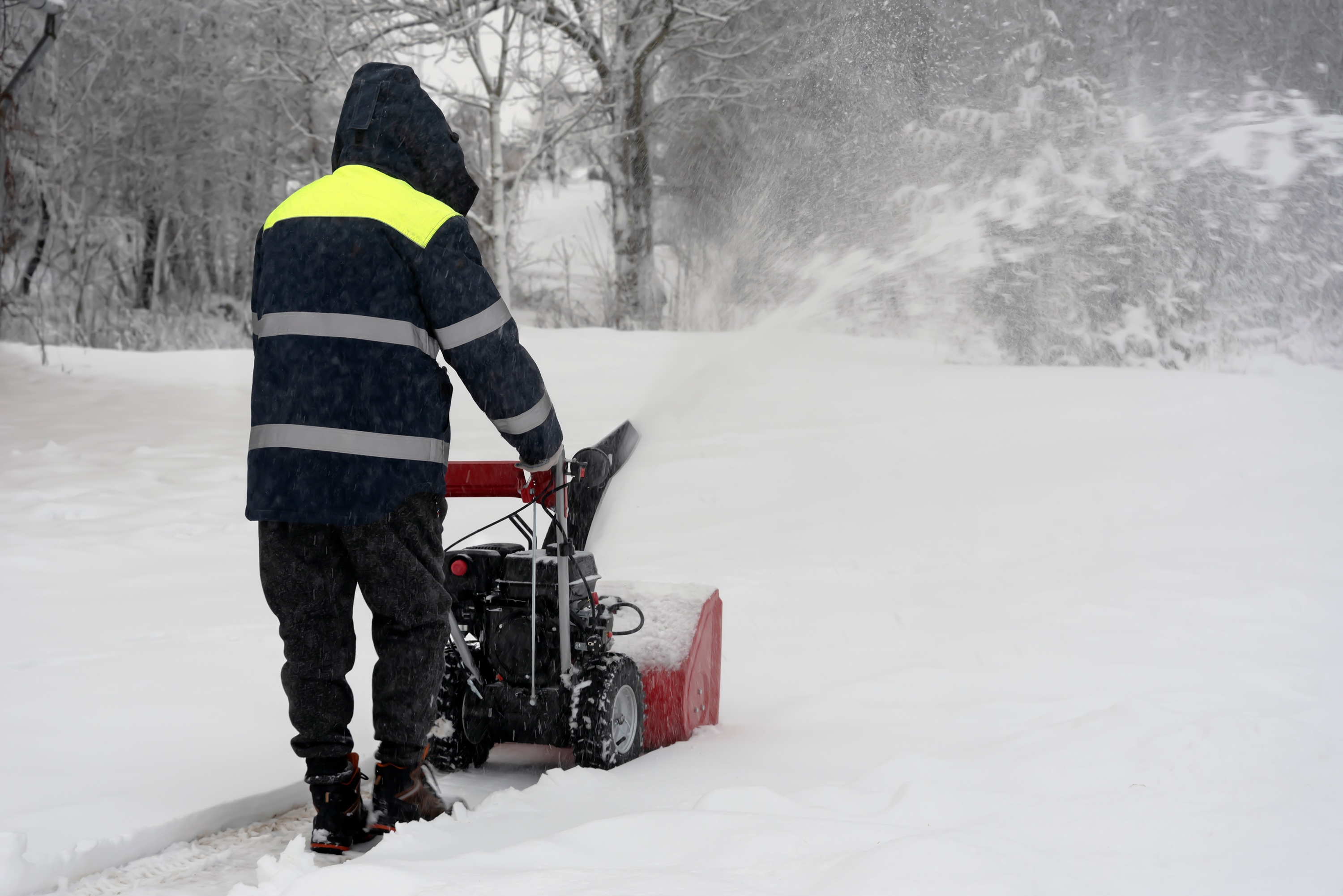 man using snowblower to remove snow