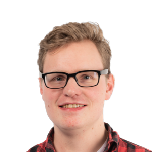 Young man with blonde hair wearing black-framed glasses and a red plaid shirt, smiling at the camera against a white background.