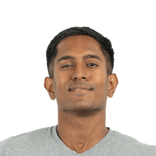 Headshot of a young man with short dark hair wearing a light gray v-neck shirt against a white background