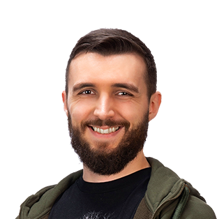 Smiling man with dark beard wearing olive green jacket over black shirt against white background