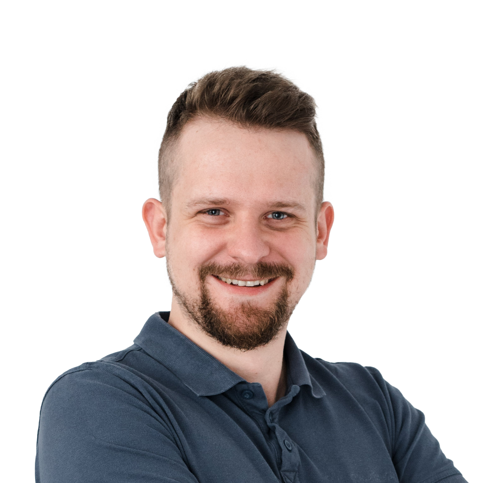 Professional headshot of a smiling man with brown hair and beard wearing a dark blue polo shirt against a white background.