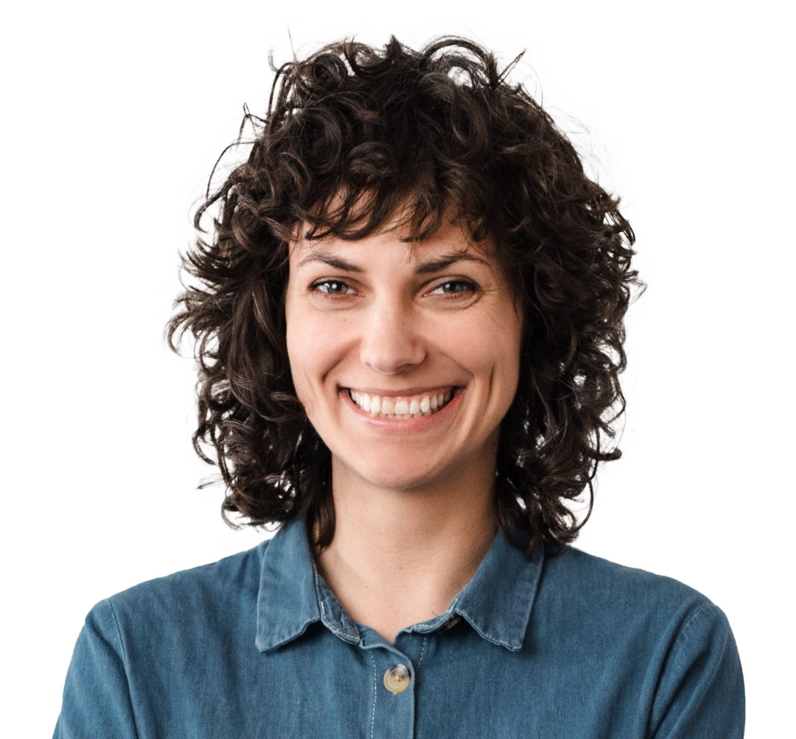 Smiling woman with dark curly hair wearing a blue denim shirt against a white background.