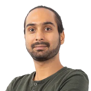 Headshot of a man with dark hair and beard wearing a olive green shirt against a white background