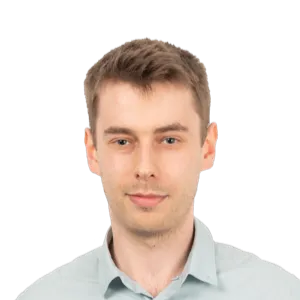 Headshot of a young man with light brown hair wearing a light blue button-up shirt against a white background.