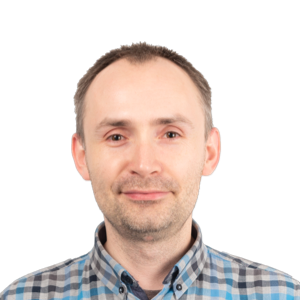 Headshot of a middle-aged man with short brown hair wearing a blue and white checkered shirt against a white background.