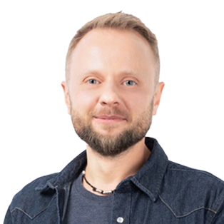 Professional headshot of a man with beard and short blonde hair wearing a dark denim shirt against white background.