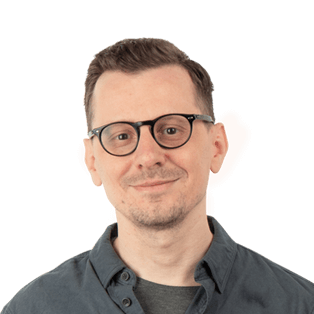 Portrait of a man wearing glasses and a dark gray shirt against a white background.