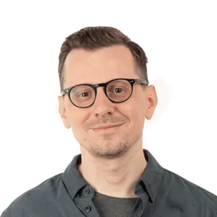 Portrait of a man wearing glasses and a dark gray shirt against a white background.