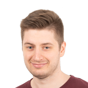 Headshot of a young man with light brown hair styled upward, wearing a maroon shirt against a white background.