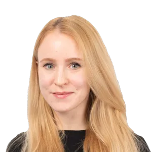 Professional headshot of a woman with long strawberry blonde hair wearing a black top against a white background.
