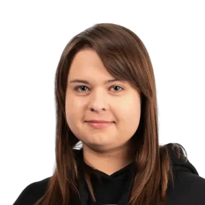 Professional headshot of a woman with long brown hair wearing a black top against a white background.