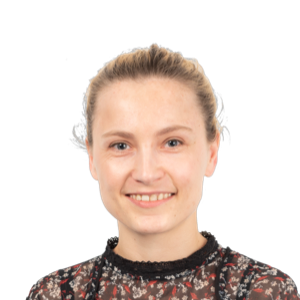 Smiling woman with blonde hair pulled back, wearing a dark patterned top against a white background.