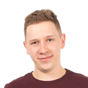 Portrait photograph of a young man with short brown hair wearing a dark maroon t-shirt against a white background.