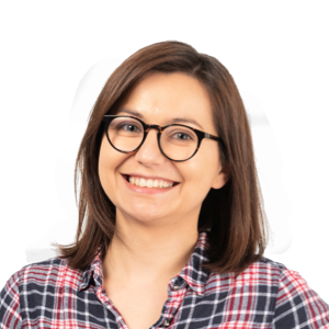 Woman wearing glasses and a plaid shirt smiling at the camera against a white background