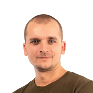 Headshot of a man with short blonde hair wearing a dark olive green t-shirt against a white background.