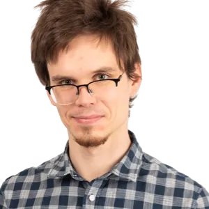 A young man with dark hair and glasses wearing a blue plaid shirt, smiling at the camera against a white background.