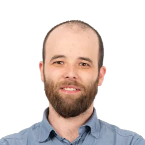 Headshot of a bearded man with light brown hair wearing a blue button-up shirt against a white background.