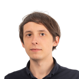 Headshot of a young man with brown hair wearing a dark collared shirt against a white background.