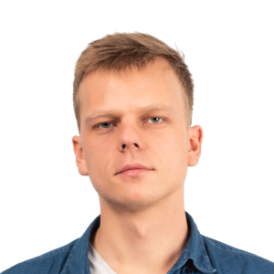 Headshot of a young man with light brown hair wearing a dark blue button-up shirt over a white undershirt against a white background.