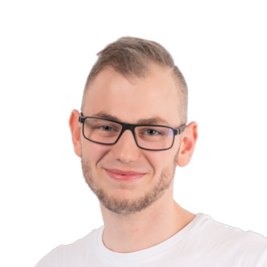 Portrait of a young man with short hair, glasses, and a light beard wearing a white t-shirt against a white background.