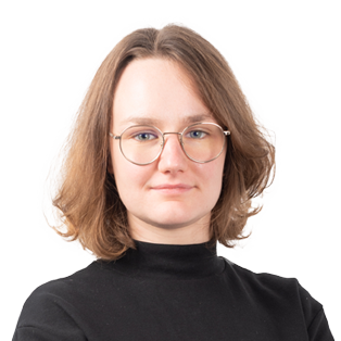 Portrait of a person with shoulder-length brown hair, glasses, and a black turtleneck against a white background.