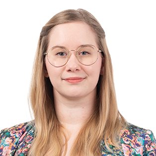 Portrait of a woman with long blonde hair and glasses wearing a colorful floral patterned shirt against a white background.
