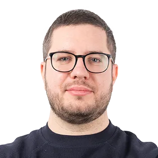 Headshot of a man with glasses and a dark shirt against a white background