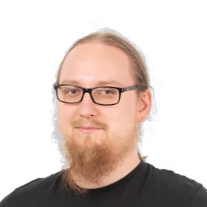 Headshot of a man with glasses, beard, and reddish-blonde hair wearing a black shirt against a white background.