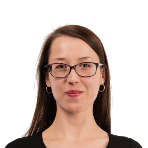 Portrait of a woman with long brown hair, glasses, and a black top against a white background.