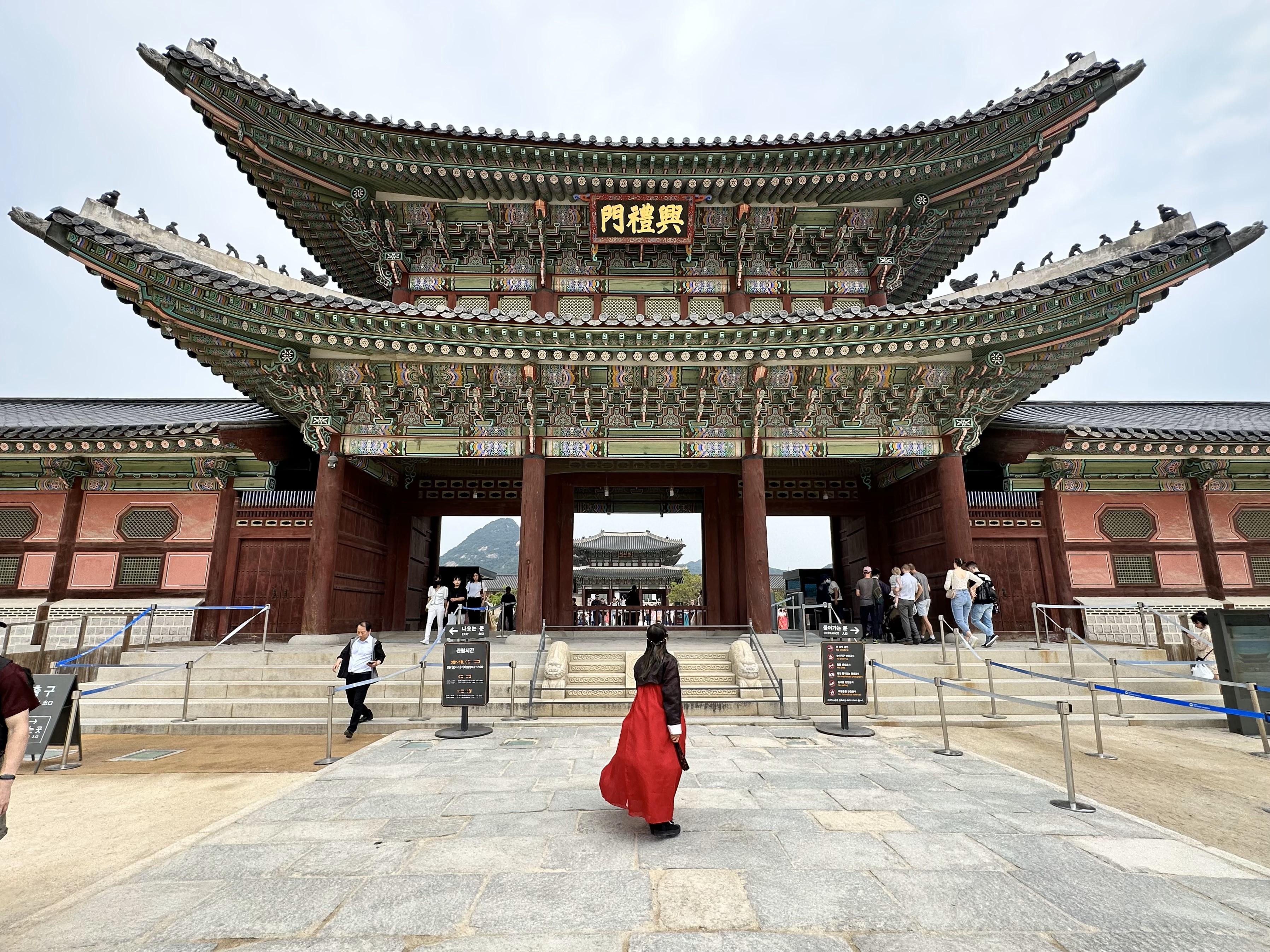 Giselle in hanbok standing in front of Gyeongbokgung Palace in Korea