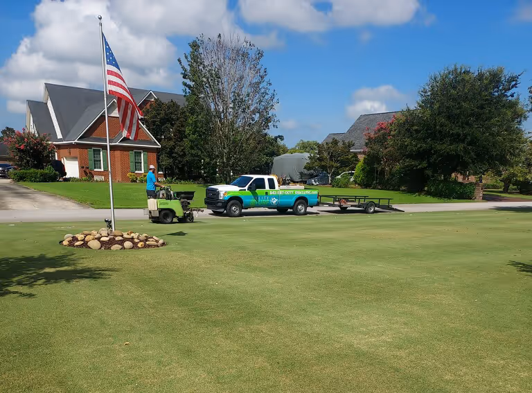 A well-maintained residential lawn with vibrant green grass and neat landscaping showcasing the results of professional lawn care services.