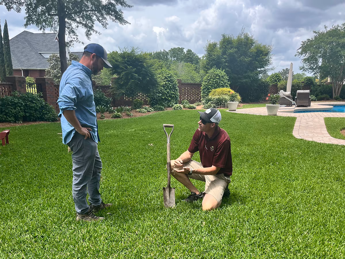 Elite Turf Service professionals providing expert lawn care advice after lawn mowing.