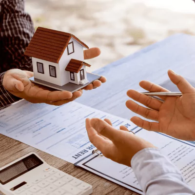 Magnifying glass placed over colorful financial reports, symbolizing analysis, review, and attention to detail.