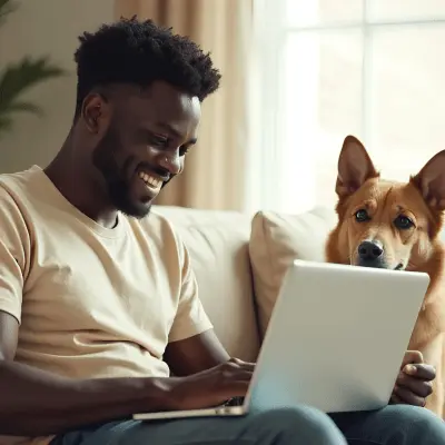 Smiling man working on laptop with dog by his side, showing confidence in mastering credit through smart financial planning.