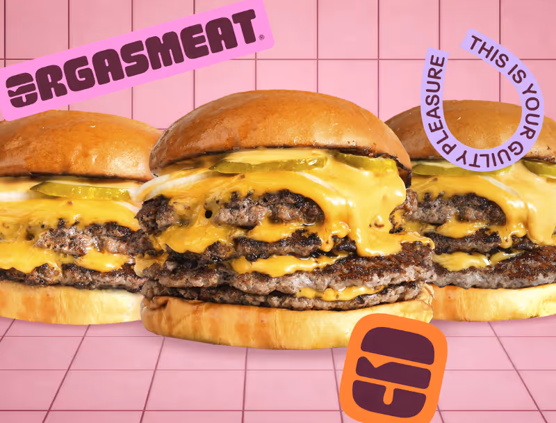Trois cheeseburgers avec plusieurs galettes de viande et fromage fondu sur fond rose à carreaux, avec le texte 'ORGASMEAT', 'THIS IS YOUR GUILTY PLEASURE' et un logo orange.