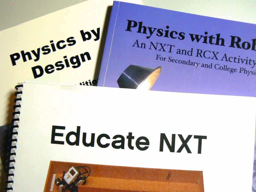 pile of books about NXT